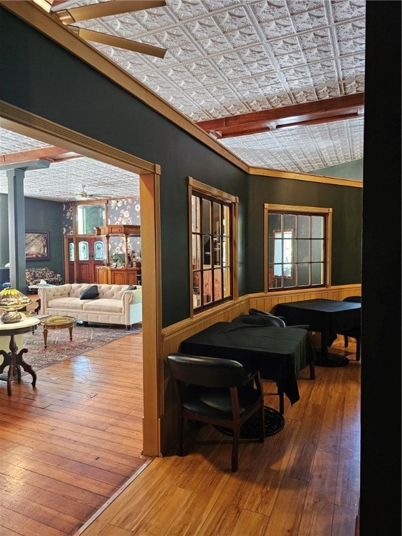 dining space featuring ornamental molding, vaulted ceiling, and wood-type flooring