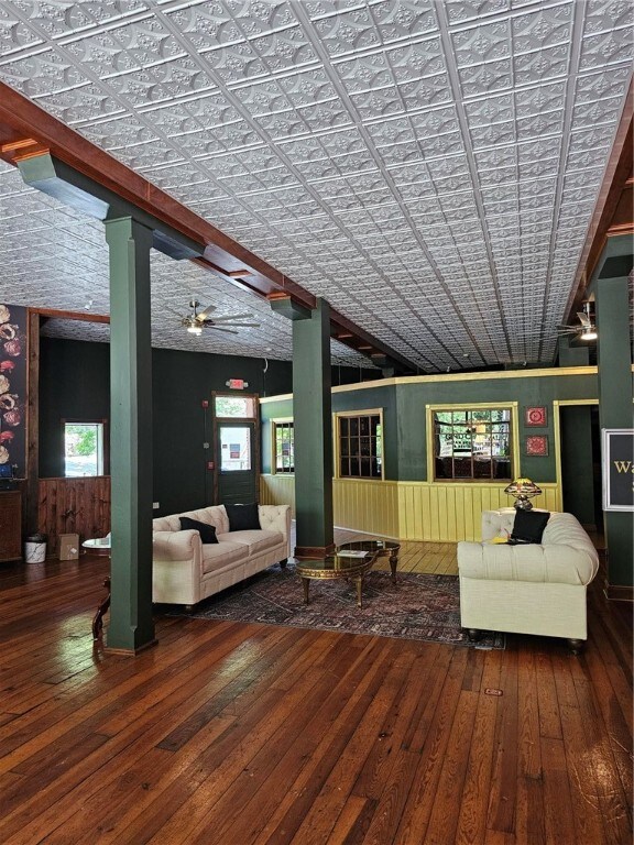 unfurnished living room with ceiling fan, lofted ceiling, and hardwood / wood-style floors