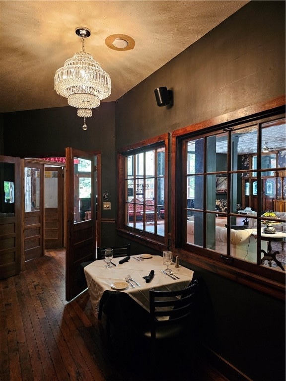 interior space with hardwood / wood-style flooring and an inviting chandelier