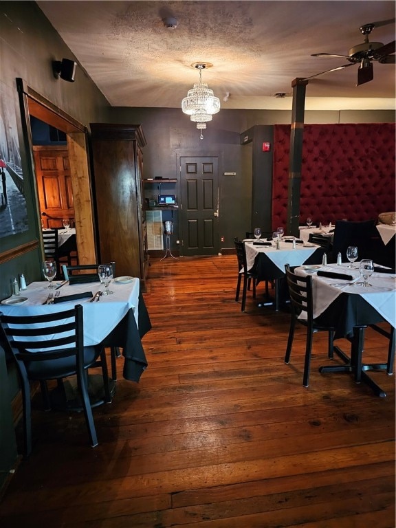 dining space featuring dark wood-type flooring and ceiling fan