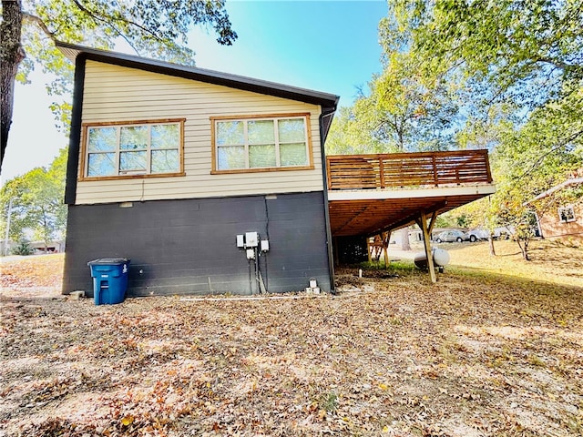 view of side of home with a wooden deck