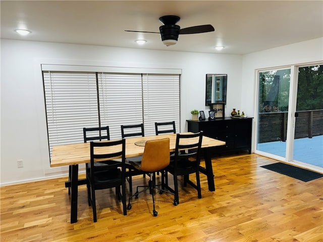 dining area with light hardwood / wood-style flooring and ceiling fan