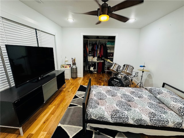 bedroom featuring hardwood / wood-style floors, a closet, and ceiling fan