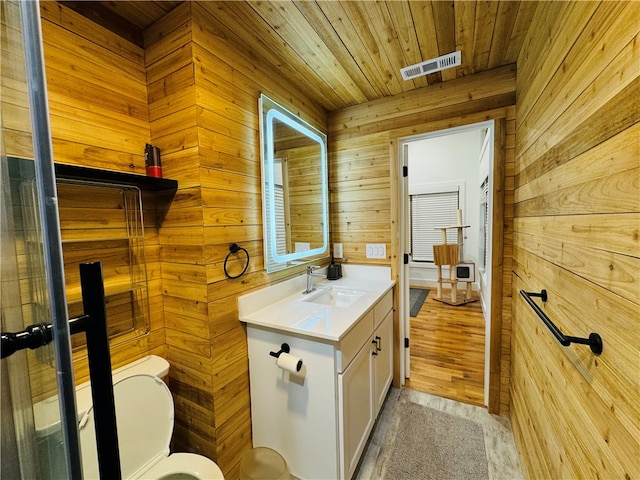 bathroom with wood ceiling, hardwood / wood-style flooring, toilet, vanity, and wood walls