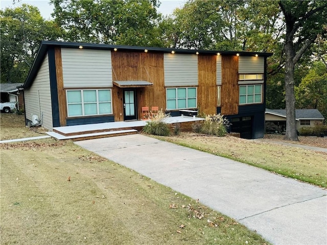 contemporary home with a front lawn