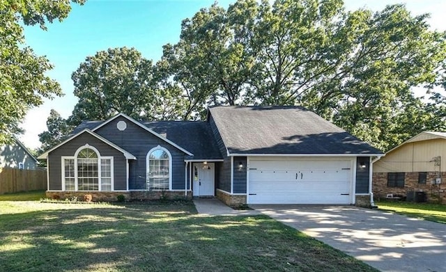 ranch-style home featuring a front yard and a garage