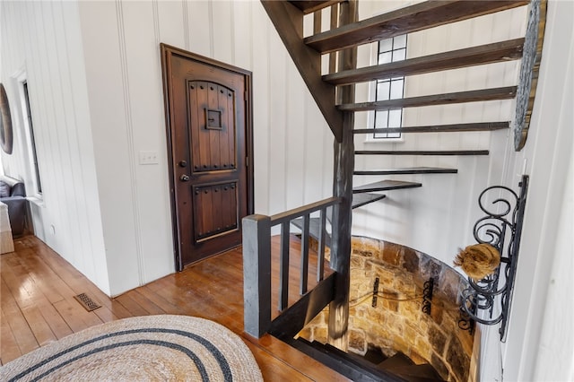 stairway featuring hardwood / wood-style floors