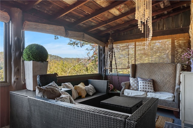 sunroom / solarium featuring lofted ceiling with beams and wood ceiling