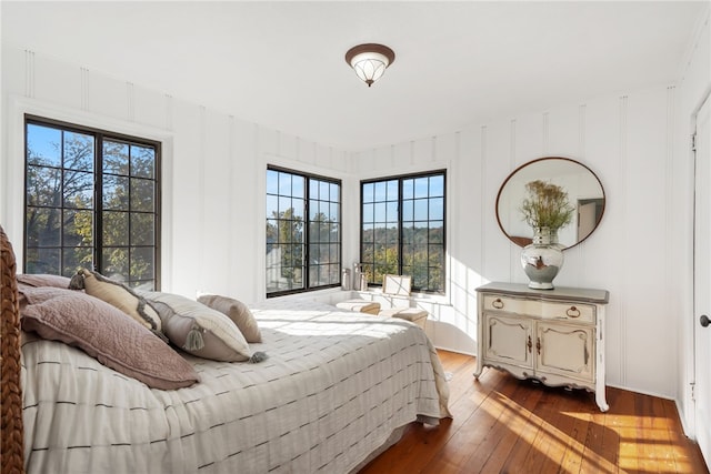 bedroom featuring hardwood / wood-style floors and multiple windows