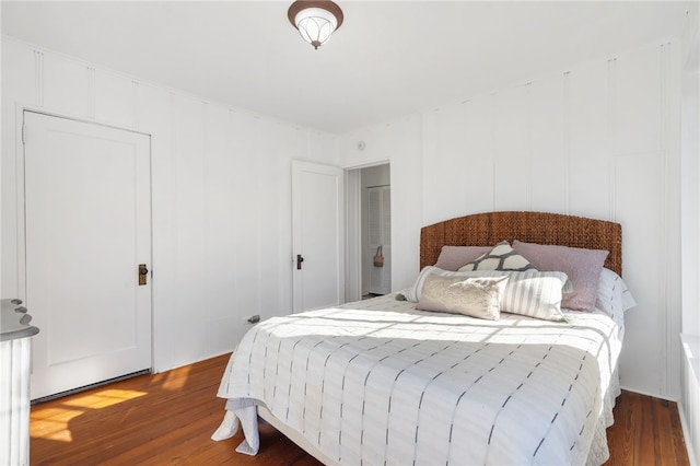 bedroom with dark hardwood / wood-style floors