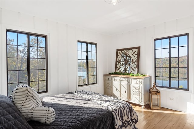 bedroom featuring multiple windows and light wood-type flooring