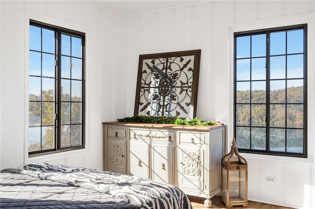 bedroom featuring multiple windows and hardwood / wood-style flooring