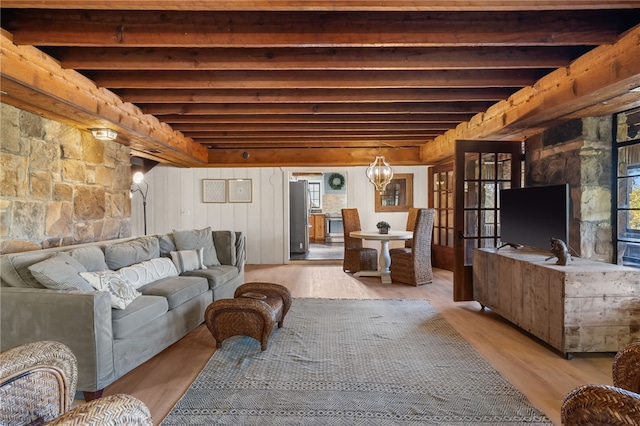 living room featuring beam ceiling and light wood-type flooring