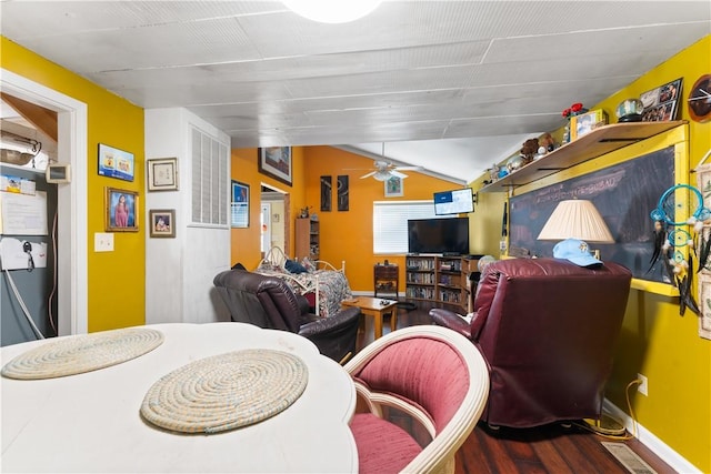dining room with vaulted ceiling, a ceiling fan, wood finished floors, and baseboards