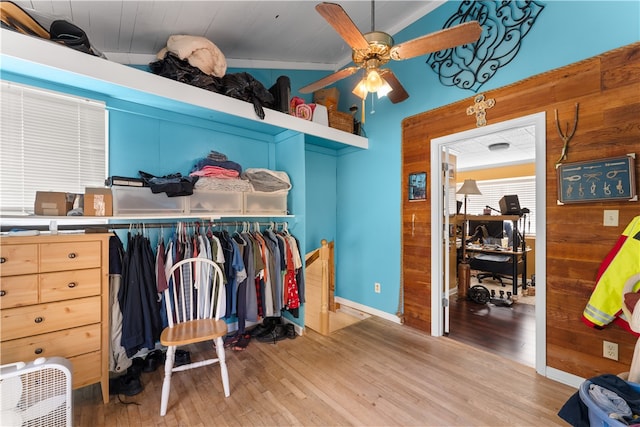 walk in closet with light hardwood / wood-style floors, lofted ceiling, and ceiling fan