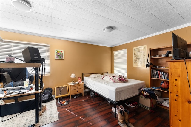 bedroom with crown molding and dark hardwood / wood-style floors