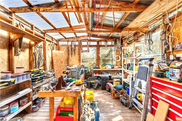 miscellaneous room featuring lofted ceiling and a workshop area