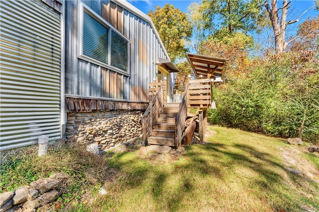 view of side of property with a lawn