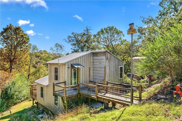 back of house with a deck