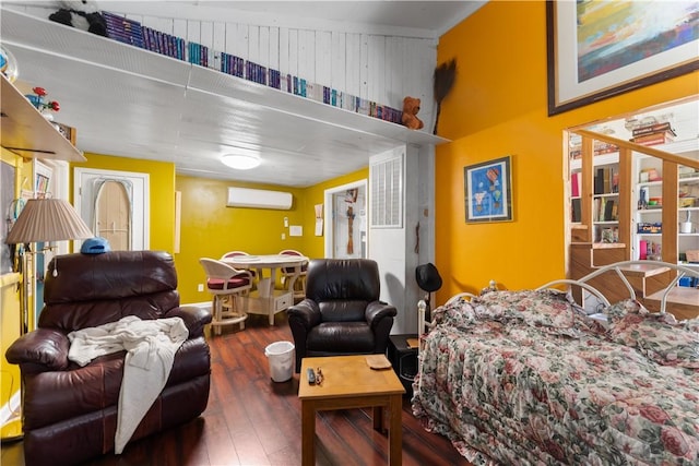 bedroom with wood walls, hardwood / wood-style floors, and a wall unit AC