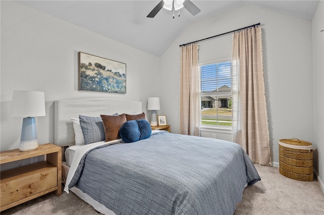 carpeted bedroom with ceiling fan and vaulted ceiling