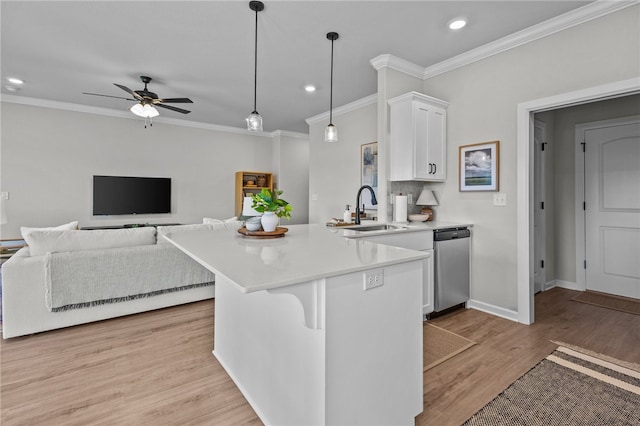 kitchen featuring dishwasher, hanging light fixtures, sink, white cabinetry, and light hardwood / wood-style floors