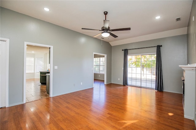 unfurnished living room featuring a fireplace, hardwood / wood-style floors, and ceiling fan