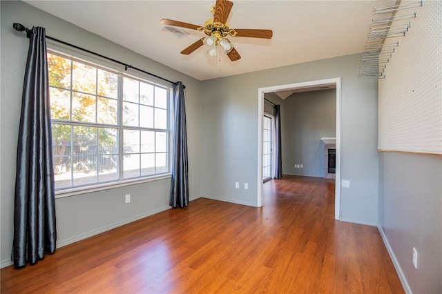 unfurnished room with hardwood / wood-style flooring and ceiling fan