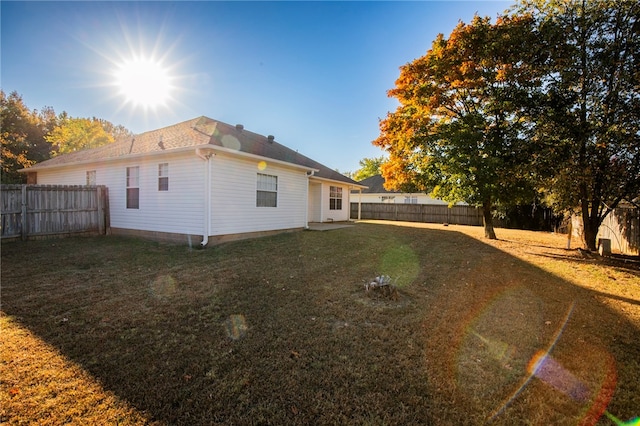 rear view of property with a yard