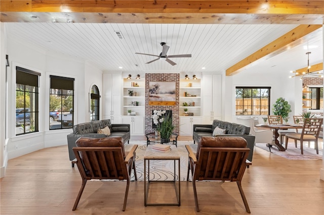 living room featuring ceiling fan with notable chandelier, built in features, wood ceiling, light hardwood / wood-style floors, and a brick fireplace