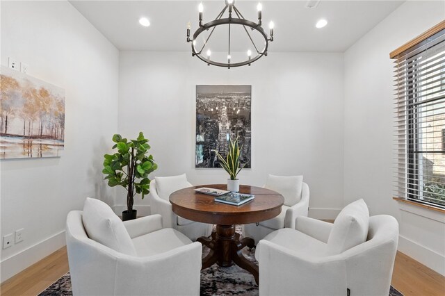 dining area featuring an inviting chandelier and light hardwood / wood-style floors