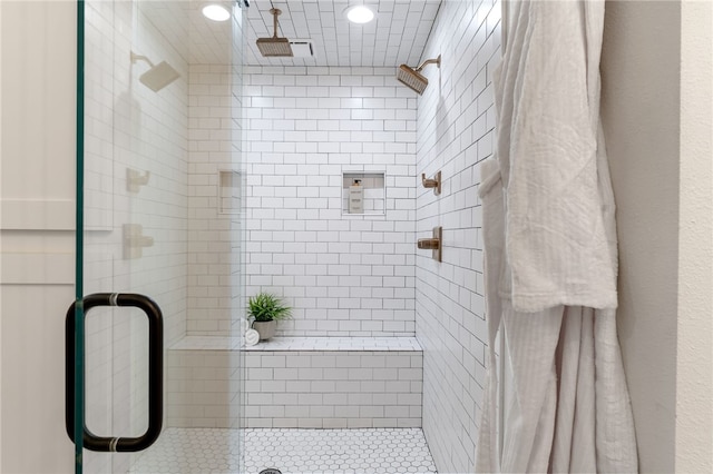 bathroom with a shower with door