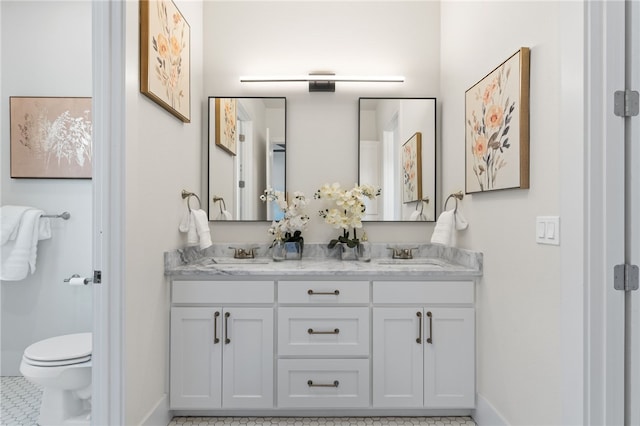 bathroom with vanity, toilet, and tile patterned flooring