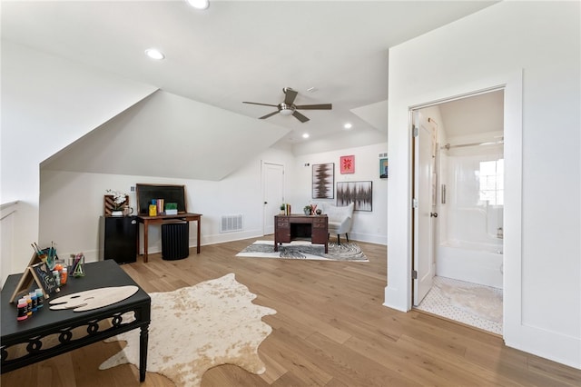 interior space with ceiling fan, light hardwood / wood-style floors, and vaulted ceiling