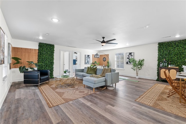 living room featuring hardwood / wood-style floors and ceiling fan