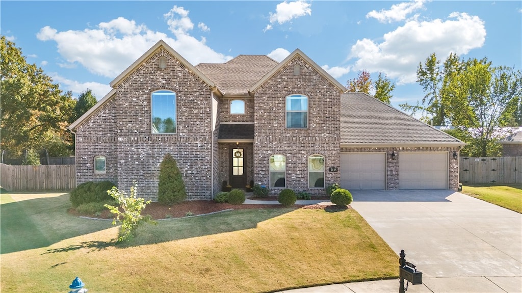 view of front of property featuring a garage and a front lawn