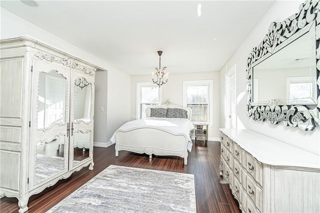 bedroom with dark wood-type flooring and a chandelier