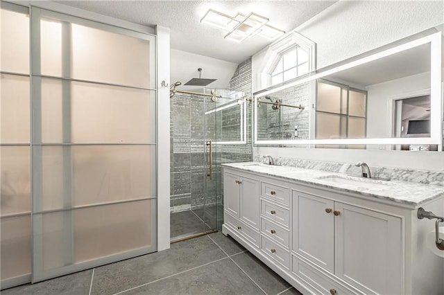 bathroom with lofted ceiling, a textured ceiling, vanity, an enclosed shower, and tile patterned floors