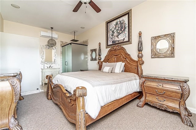 carpeted bedroom with ensuite bath, a wall mounted AC, and ceiling fan