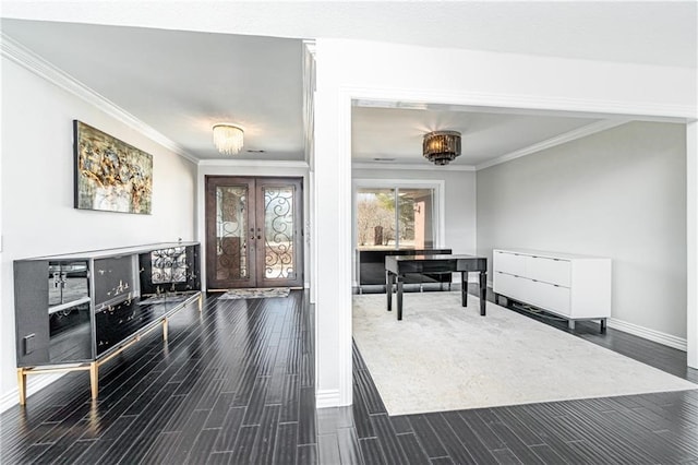 entrance foyer featuring ornamental molding, dark wood-type flooring, and french doors