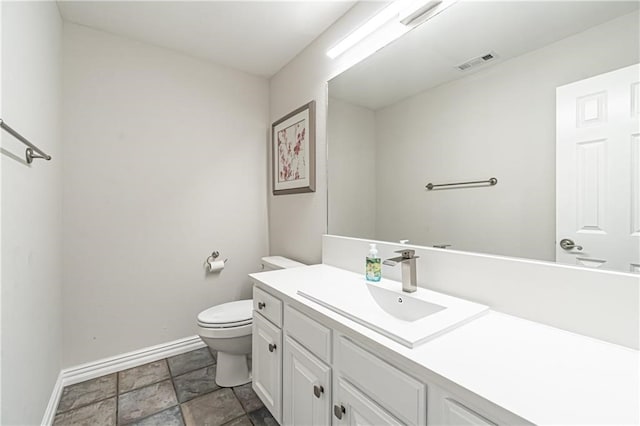 bathroom with toilet and vanity