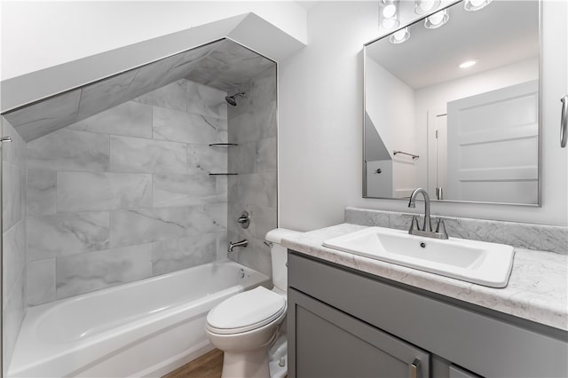 full bathroom with toilet, tiled shower / bath combo, and vanity