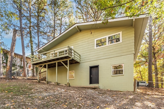 rear view of property featuring a deck