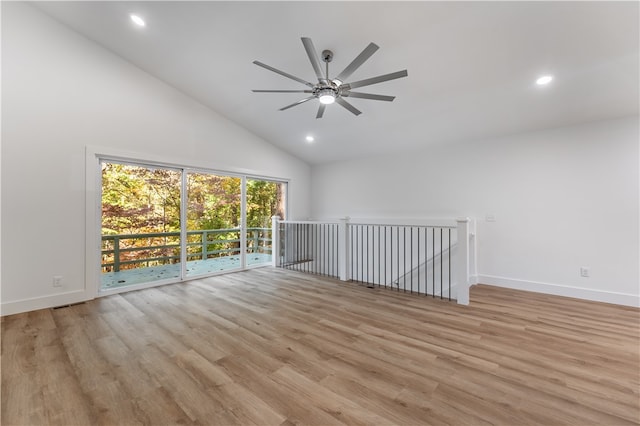 empty room with ceiling fan, light hardwood / wood-style flooring, and high vaulted ceiling