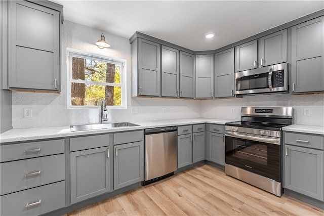 kitchen featuring gray cabinets and appliances with stainless steel finishes