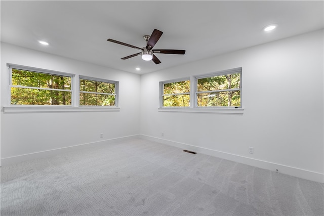 spare room featuring ceiling fan and carpet floors