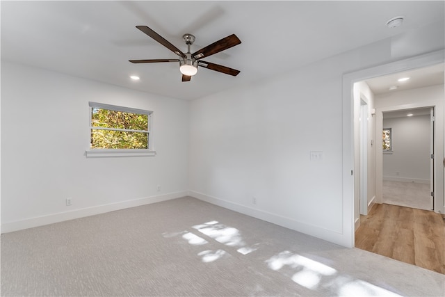 spare room with light wood-type flooring and ceiling fan