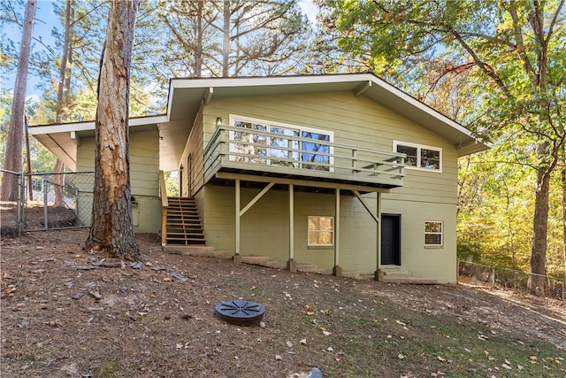 back of house featuring a wooden deck