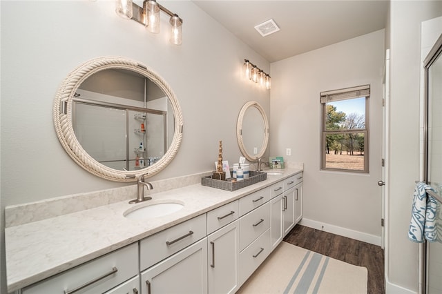 bathroom with vanity, hardwood / wood-style flooring, and an enclosed shower