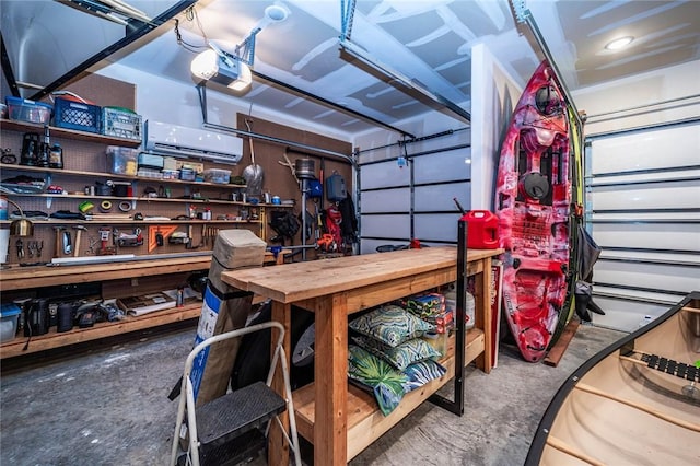 114 Ledgewood, Berryville, AR 72616 - garage featuring a wall unit AC, a garage door opener, and a workshop area